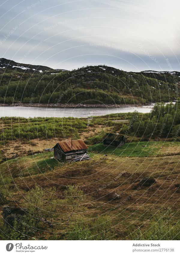 Abandoned house on shore in mountains Landscape scenery Mountain House (Residential Structure) abandoned Old Vantage point Exterior River Building Wanderlust