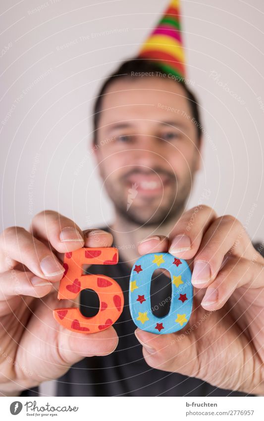 Man holding two numbers in his hand, birthday party. Party Event Feasts & Celebrations Birthday Adults Face Hand Fingers 1 Human being Hat Decoration