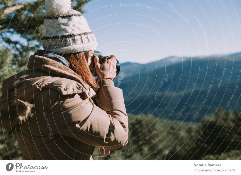 brunette girl in wool hat and brown coat takes a picture Lifestyle Healthy Leisure and hobbies Hiking Camera Technology Human being Feminine Young woman