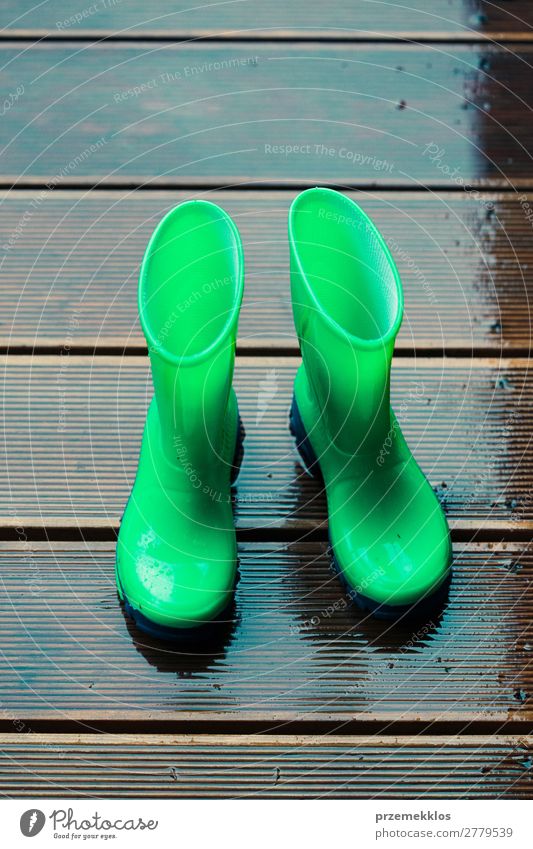 Rain boots standing on a wooden porch while raining Joy Summer Child Human being Woman Adults Man Weather Coat Footwear Boots Rubber boots Small Wet Cute Green