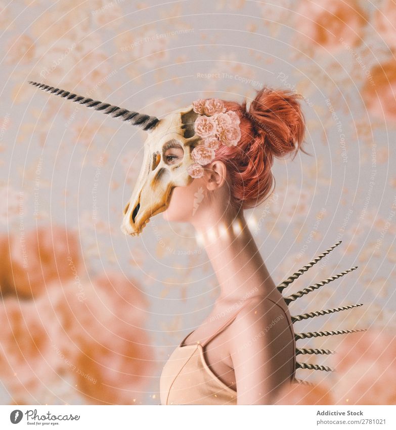 Woman with long neck wearing unicorn skull on head Death's head horned animal Neck Long Elongated Attractive beauitful Wear Bone Animal Horn Skeleton Body Wild