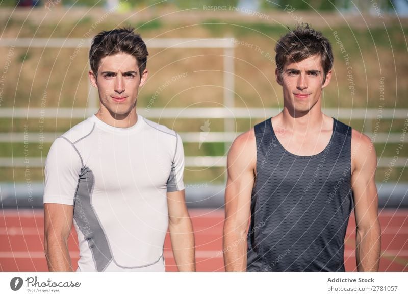 Two sportsmen posing on stadium Stadium sportsman Posture Man Sportswear Fitness 2 Practice Athlete Adults Muscular Health care Stand Sprinter Athletic Resting