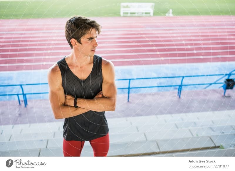 Young sportsman posing on stadium Man Stadium Posture Rest Sports Fitness hands crossed Practice Athlete Muscular Relaxation Adults Sprinter Break Sportswear