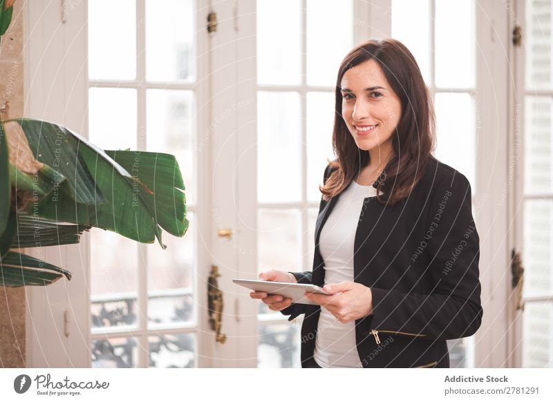 Young smiling woman standing with tablet Woman Tablet computer Smiling Technology Posture Cheerful Stand Gadget Modern Digital Businesswoman Entrepreneur