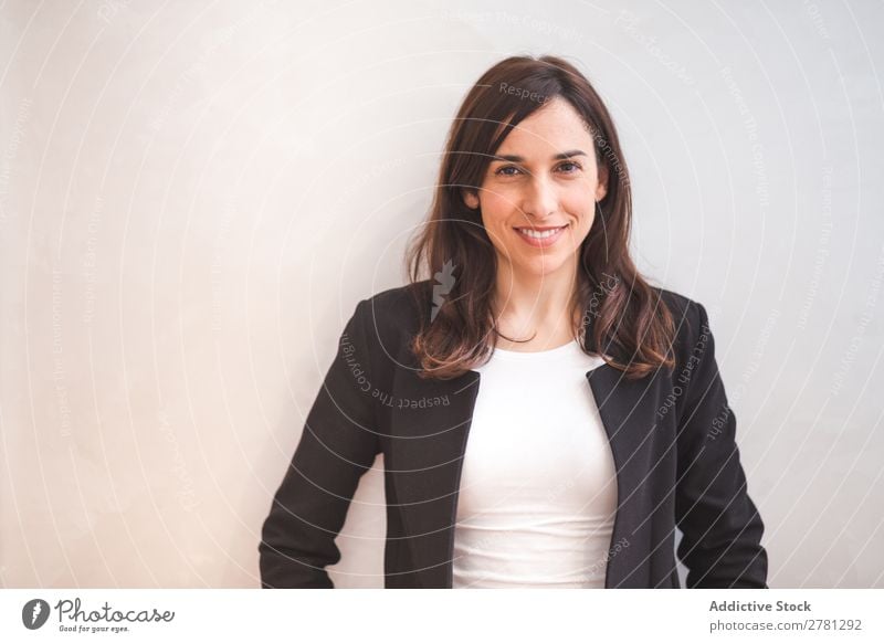 Young smiling woman in suit posing Businesswoman Posture Smiling Gesture Portrait photograph Cheerful Stand Successful Self-confident Positive crossed arms