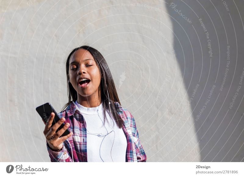 Front view of a young smiling african american woman standing Lifestyle Happy Beautiful Entertainment Music Telephone Human being Feminine Young woman