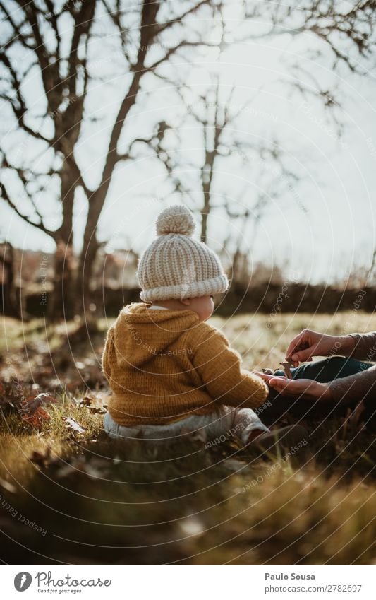 Baby in nature Lifestyle Human being Feminine Child Girl 1 1 - 3 years Toddler Nature Beautiful weather Leaf Forest Coat Fur coat Hat Discover Catch To enjoy