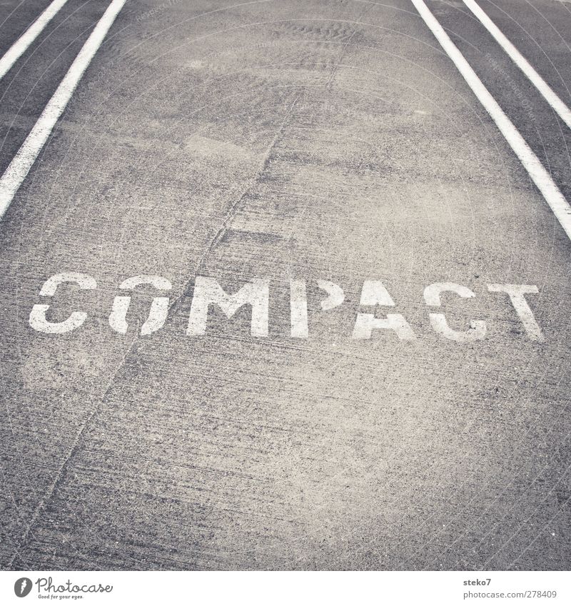 compact class Street Town Gray White Line Marker line Small car Category Characters Regulation Parking lot Black & white photo Exterior shot Detail Deserted