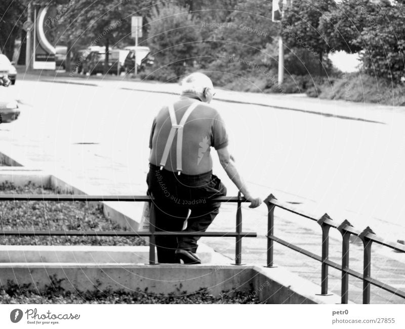 Old man, waiting Man Senior citizen Fence Sidewalk Front garden Suspenders Overexposure Sunlight Glistening Brilliant Male senior Wait Street Sit