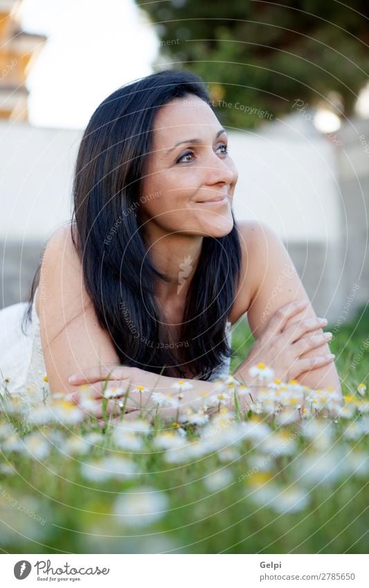 Brunette woman on a flowered meadow Lifestyle Joy Happy Beautiful Face Wellness Relaxation Vacation & Travel Summer Sun Garden Human being Woman Adults Nature