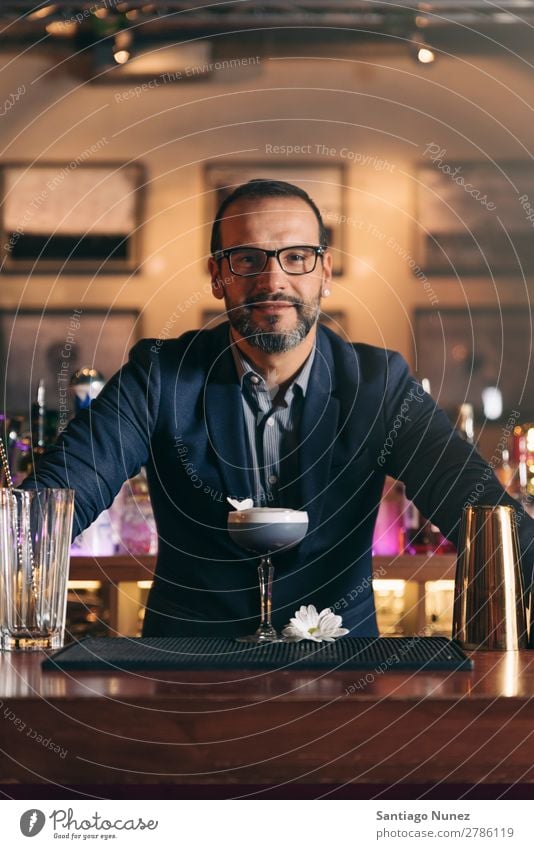 Barman is making cocktail at night club. Cocktail shaker barman bartender Waiter Man Stir mixologist adding Alcoholic drinks Business Club Drinking Professional