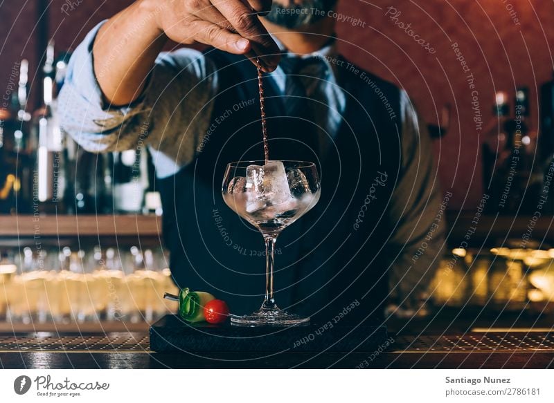 Barman is making cocktail at night club. Cocktail shaker barman bartender Waiter Man Stir mixologist adding Alcoholic drinks Business Club Drinking Professional