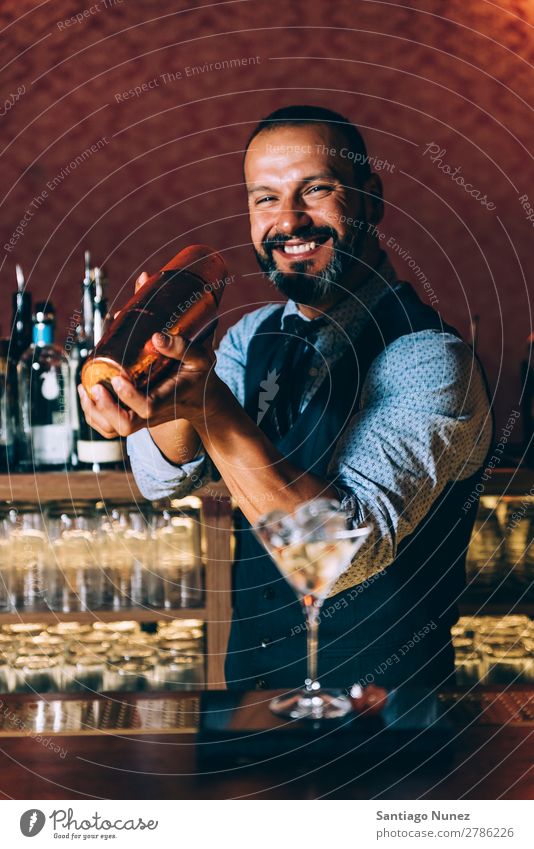 Barman is making cocktail at night club. Cocktail shaker barman bartender Waiter Man Stir mixologist adding Alcoholic drinks Business Club Drinking Bottle