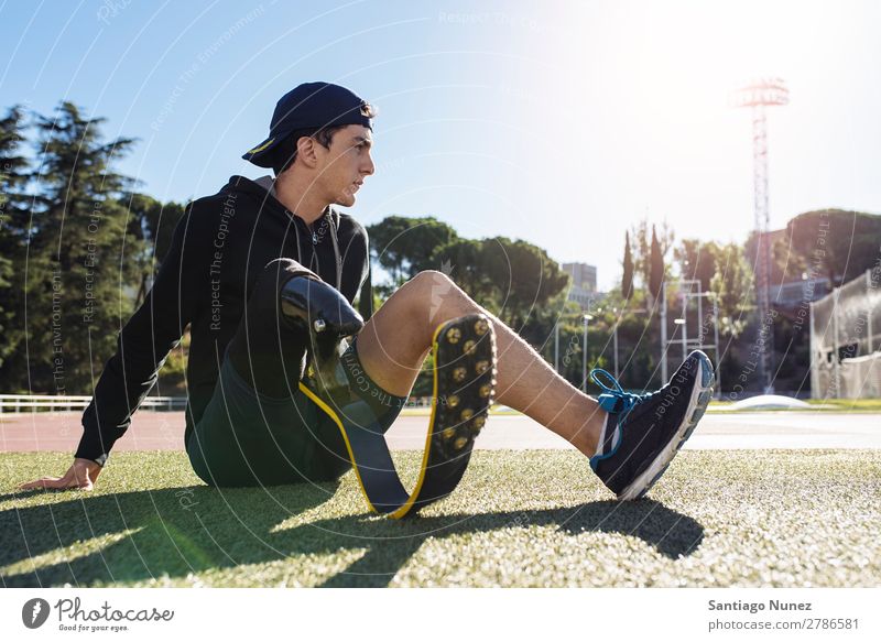 Portrait of disabled man athlete with leg prosthesis. Man Runner Portrait photograph Athlete Sports prosthetic Handicapped paralympic amputation Seat Sit