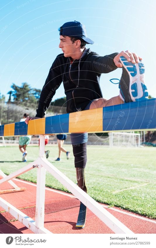 Disabled man athlete stretching with leg prosthesis. Man Runner Stretching Athlete Sports prosthetic Handicapped disabled paralympic amputation amputee invalid