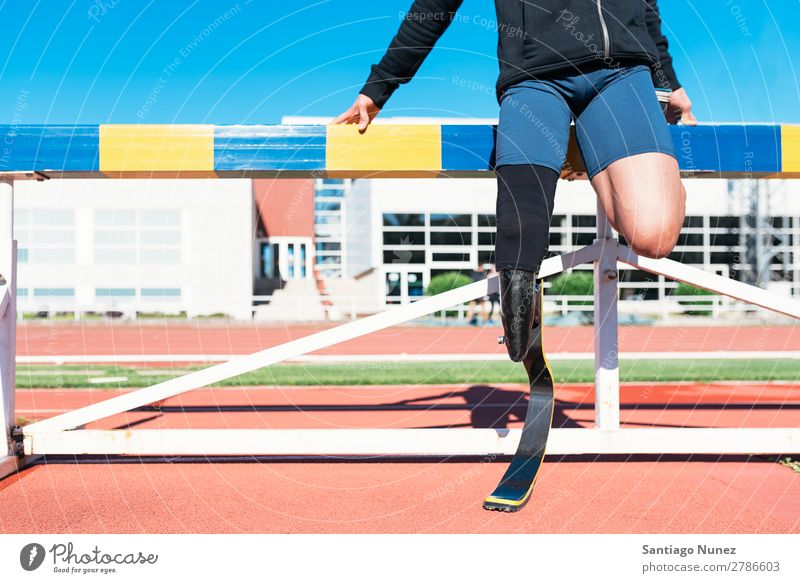 Disabled man athlete stretching with leg prosthesis. Man Runner Stretching Athlete Sports prosthetic Handicapped disabled paralympic amputation amputee invalid