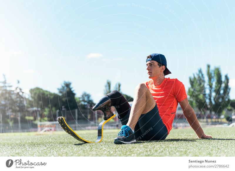 Disabled man athlete taking a break. Man Runner Portrait photograph Athlete Sports prosthesis prosthetic Handicapped disabled paralympic amputation Seat Sit