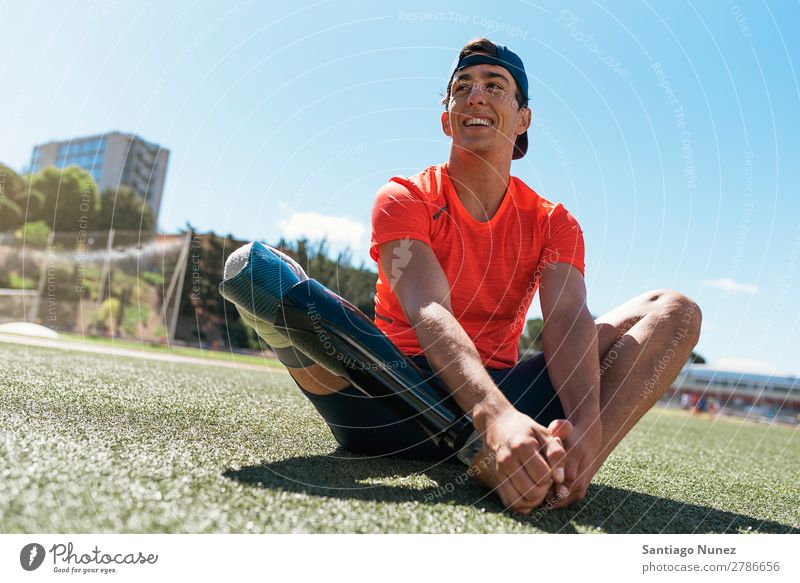 Disabled man athlete stretching with leg prosthesis. Man Runner Stretching Athlete Sports prosthetic Handicapped disabled paralympic amputation Happy Smiling