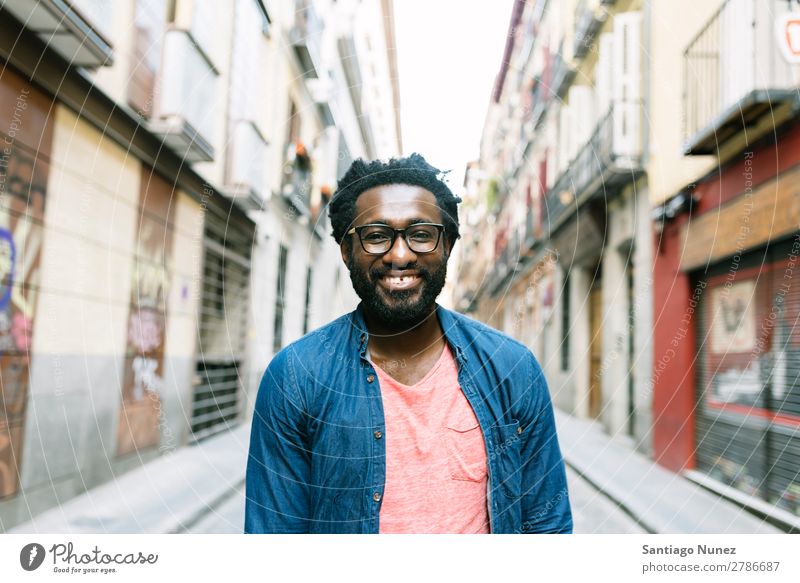 Handsome young african man in the street. Man African Lifestyle Listening Black American Town Portrait photograph handsome Stand Hipster Dreadlocks Student