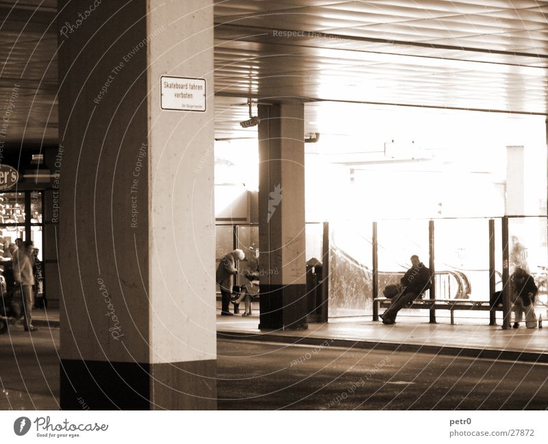 bus station Bus terminal Concrete Light Column Asphalt Escalator Architecture Human being Shadow Contrast Gloomy Signs and labeling Station