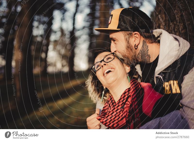 Happy couple hugging near tree in park Couple Embrace Park Tree embracing Back Wood Forest Youth (Young adults) Cheerful bearded Man Woman Joy Hipster Walking