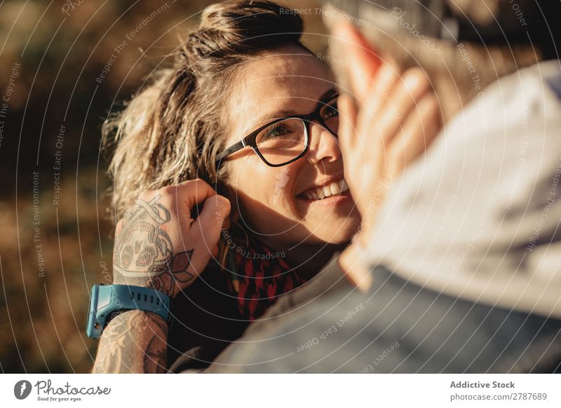 Happy couple hugging and kissing near tree in park Couple Embrace Park Tree embracing Back Wood Forest Youth (Young adults) Cheerful bearded Man Woman Joy