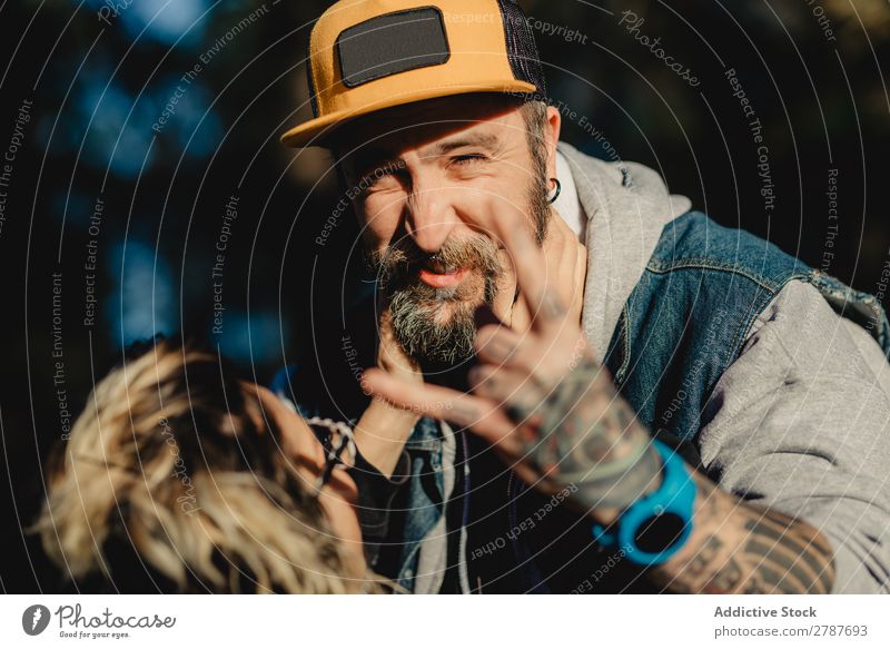 Happy couple hugging and kissing near tree in park Couple Embrace Park Tree embracing Back Wood Forest Youth (Young adults) Cheerful bearded Man Woman Joy