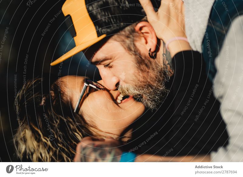 Happy couple hugging and kissing near tree in park Couple Embrace Park Tree embracing Back Wood Forest Youth (Young adults) Cheerful bearded Man Woman Joy