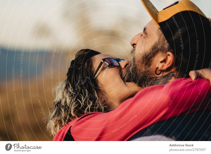 Happy couple hugging and kissing near tree in park Couple Embrace Park Tree embracing Back Wood Forest Youth (Young adults) Cheerful bearded Man Woman Joy