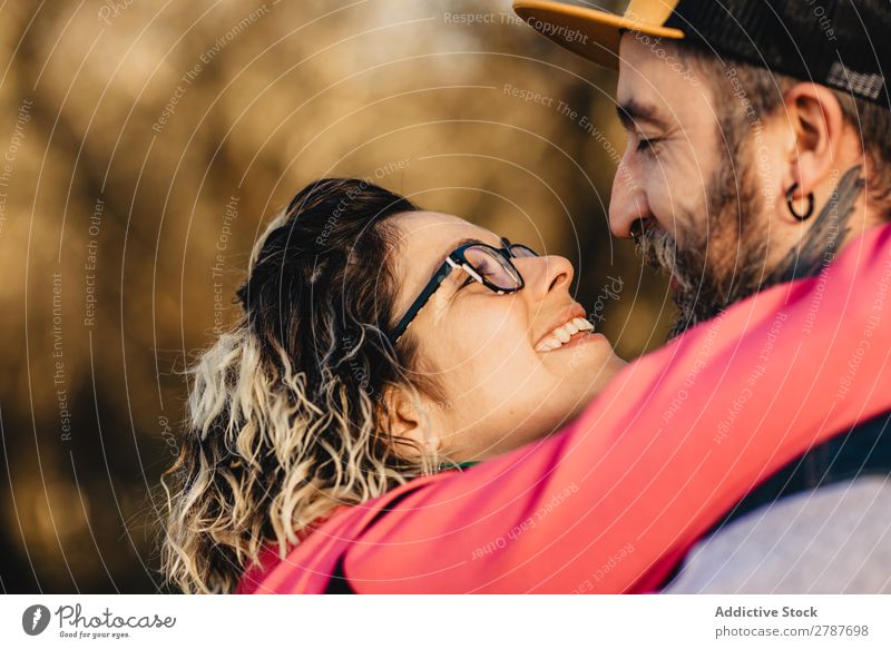 Happy couple hugging and kissing near tree in park Couple Embrace Park Tree embracing Back Wood Forest Youth (Young adults) Cheerful bearded Man Woman Joy