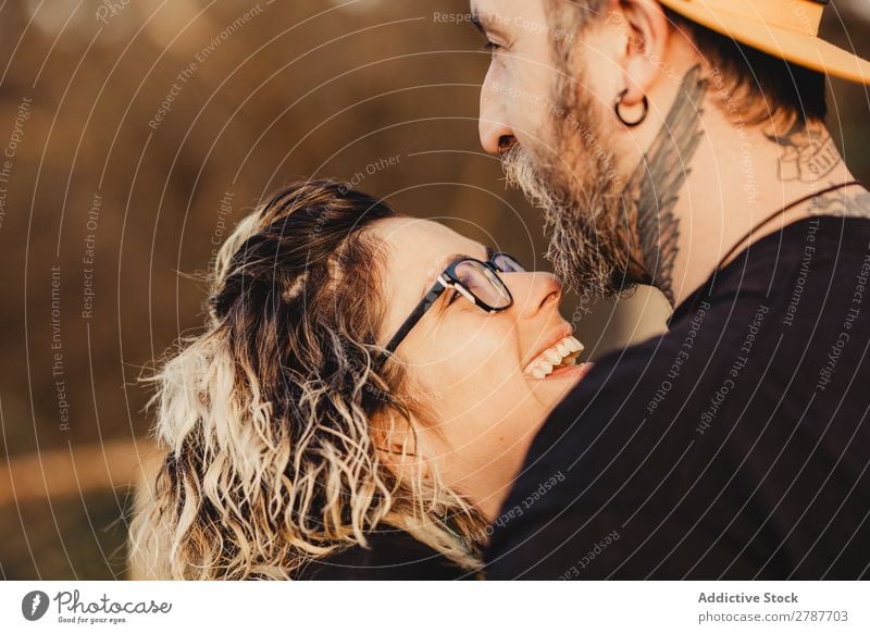 Happy couple hugging and kissing near tree in park Couple Embrace Park Tree embracing Back Wood Forest Youth (Young adults) Cheerful bearded Man Woman Joy