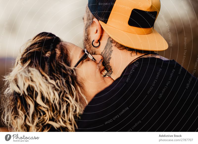 Happy couple hugging and kissing near tree in park Couple Embrace Park Tree embracing Back Wood Forest Youth (Young adults) Cheerful bearded Man Woman Joy