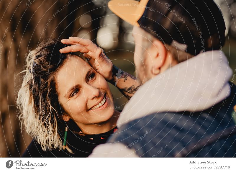 Happy couple hugging near tree in park Couple Embrace Park Tree embracing Back Wood Forest Youth (Young adults) Cheerful bearded Man Woman Joy Hipster Walking