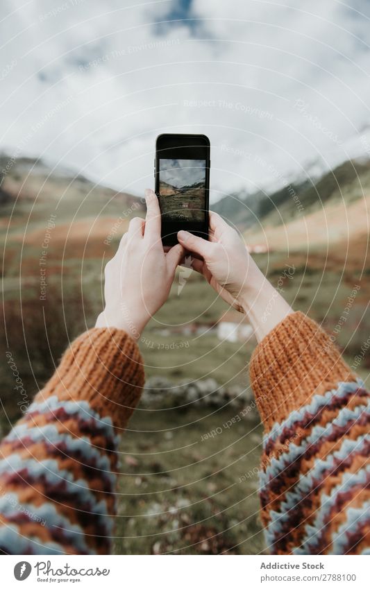 Woman taking photo on smartphone of valley with high hills in cloudy weather PDA Valley Hill Clouds Pyrenees Photography Take Lady Cellphone shooting Mountain