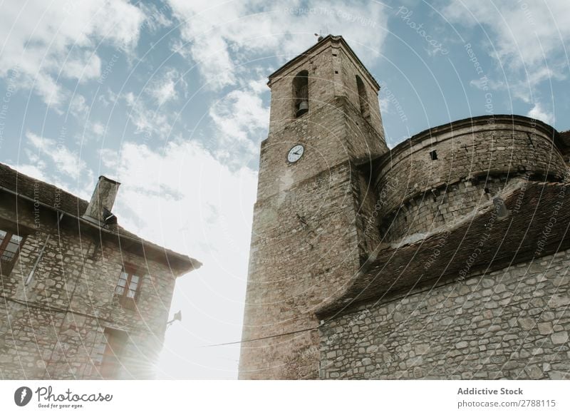 Tower near brick building and cloudy sky Brick Building Sky Pyrenees Clouds Construction Heaven Blue Height Facade Weather Beautiful Architecture Roof Exterior