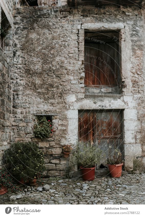 Court between grey stone building Building Stone Court building Pyrenees Grass Rock House (Residential Structure) Window yard Wood Gray Old Red Construction