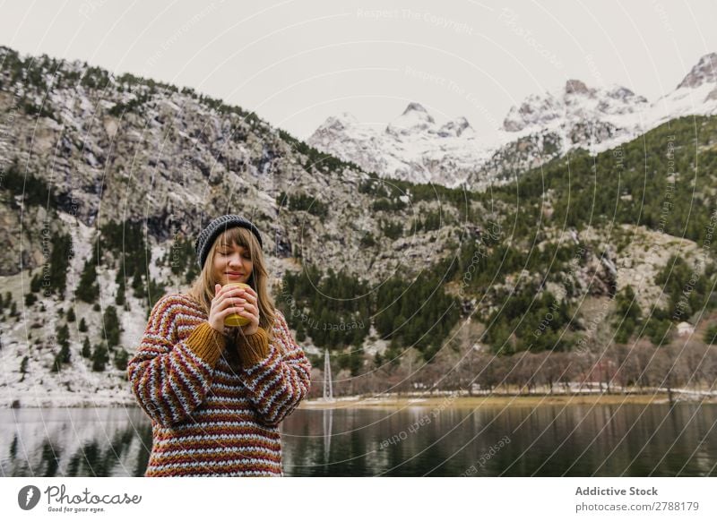 Woman on seat near wonderful lake between hills in snow Lake Hill Seat Snow Pyrenees Wonderful Water Surface Mountain Lady Height Tree Amazing Vantage point