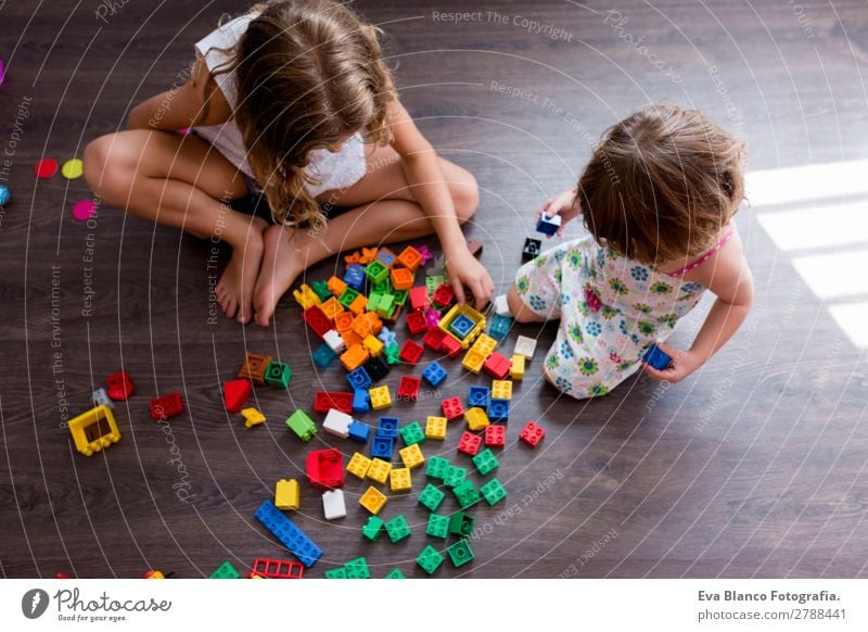 two beautiful sibling sisters playing at home Joy Happy Playing Kindergarten Child School Human being Feminine Baby Toddler Girl Family & Relations Infancy