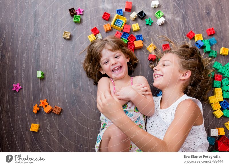 two beautiful sisters playing at home Lifestyle Joy Leisure and hobbies Playing House (Residential Structure) Kindergarten Child School Baby Toddler Girl Sister