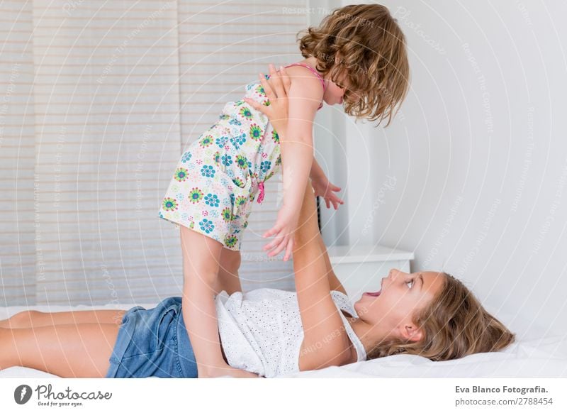 Two beautiful sister kids playing on bed Lifestyle Joy Beautiful Leisure and hobbies Playing Summer Bed Bedroom Child Schoolchild Human being Feminine Toddler