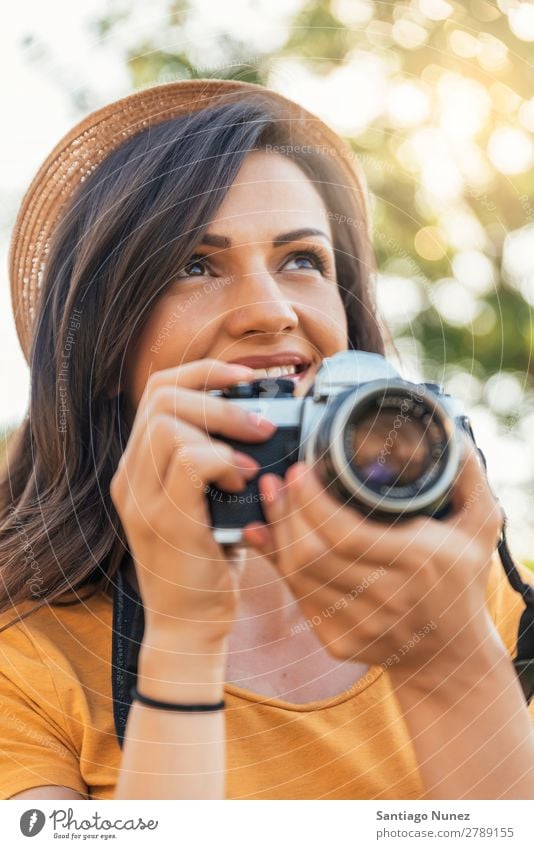 Smiling young woman using a camera to take photo. Photographer Woman Photography Camera Youth (Young adults) Girl Digital White Leisure and hobbies 1 Take