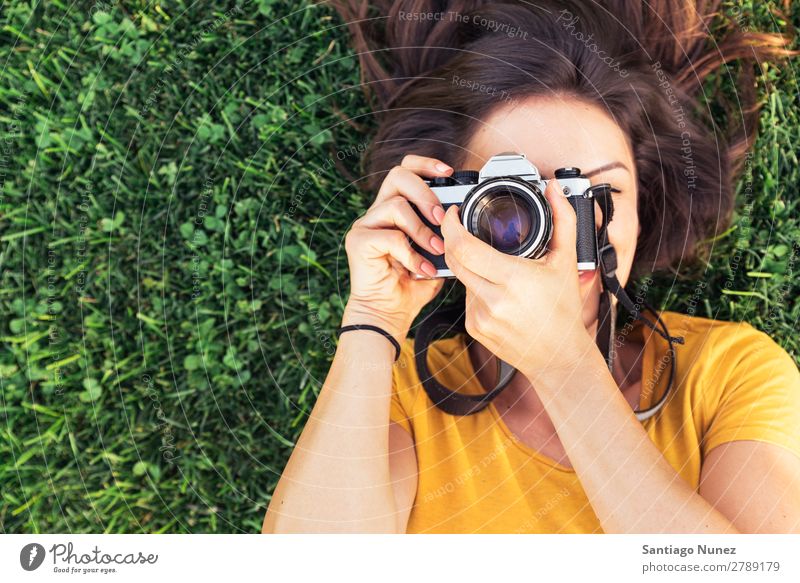 Smiling young woman using a camera to take photo. Photographer Woman Photography Camera Youth (Young adults) Girl Digital White Leisure and hobbies 1 Take