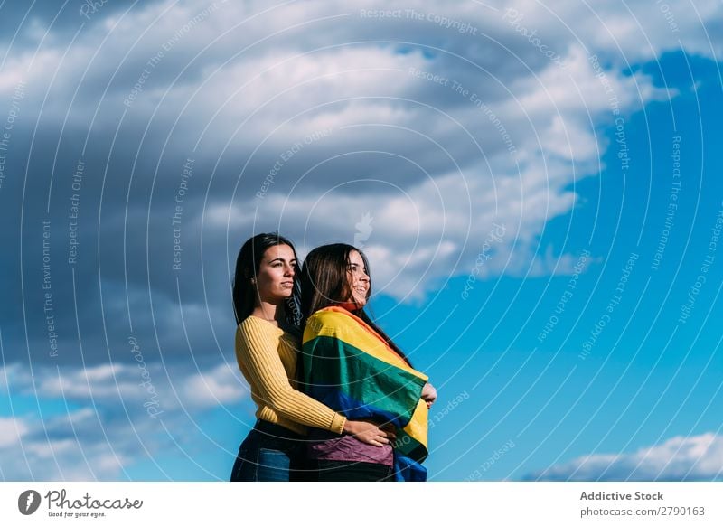 Young girl couple with gay flag millennial Symbols and metaphors Emotions Relationship Affection bisexual Point in time Homosexual Joy Love Freedom Couple