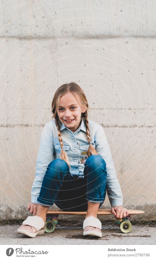 kid posing with skateboard Child Playing Modern Leisure and hobbies Youth (Young adults) Joy Girl Street Town Happiness Ice-skates Person wearing glasses