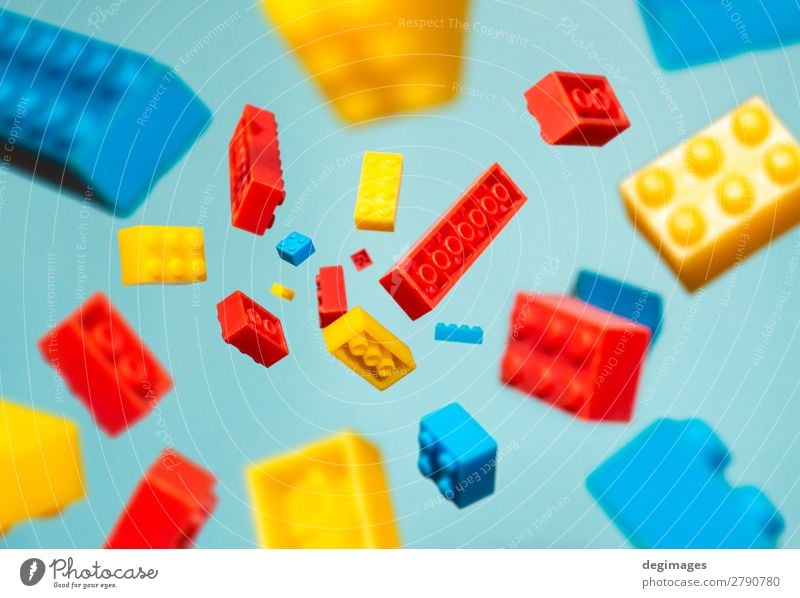 Floating Plastic geometric cubes in the air. Construction toys Design Playing Child Infancy Toys Brick Build Movement Blue Colour blocks falling background rows