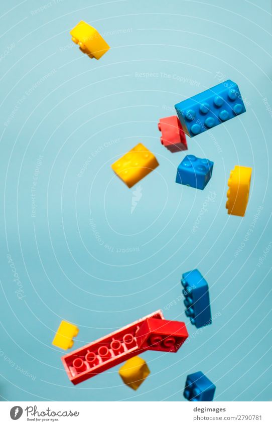 Floating Plastic geometric cubes in the air. Construction toys Design Playing Child Infancy Toys Brick Build Movement Blue Colour blocks falling background rows