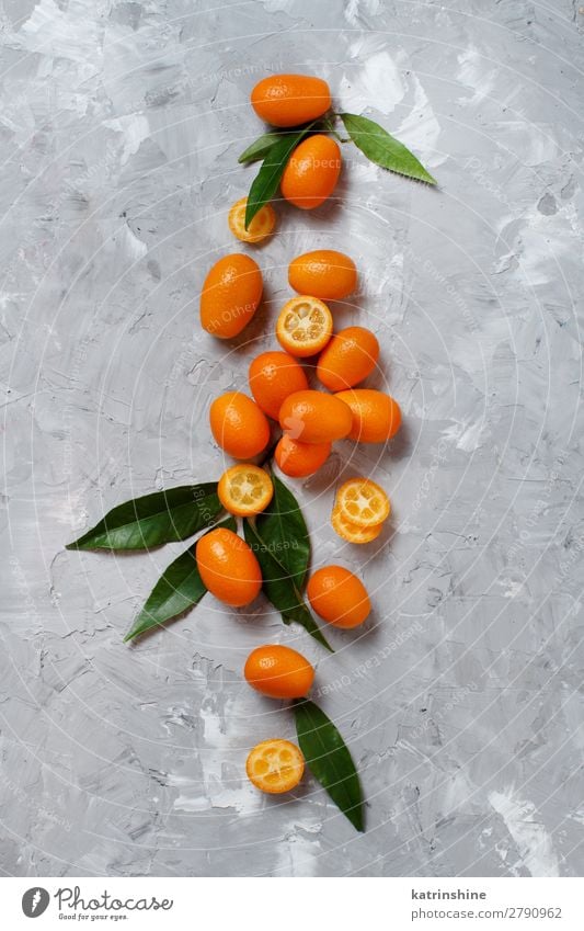 Kumquat fruits on a grey background Fruit Dessert Nutrition Vegetarian diet Diet Exotic Group Leaf Fresh Natural Above Juicy Yellow Gray Colour citrus cumquat