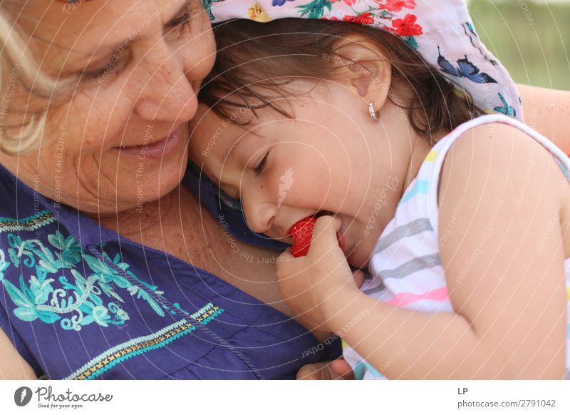 Adult woman holding a child eating a strawberry Lifestyle Joy Wellness Harmonious Well-being Contentment Senses Relaxation Calm Children's game