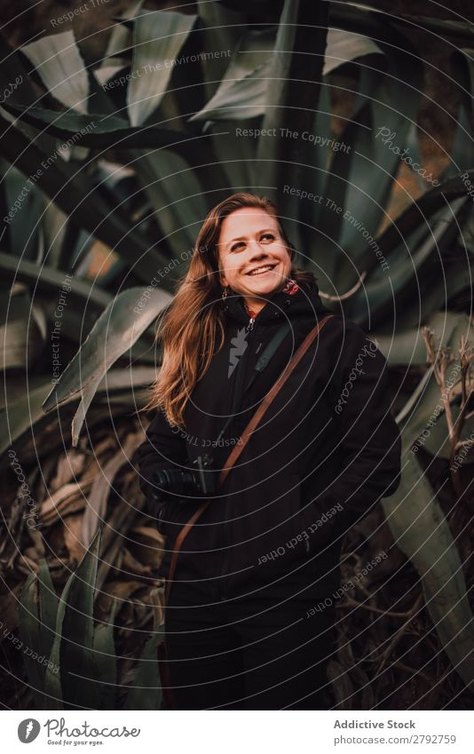 Woman in coat with camera near plants Camera Coat Plant Chechaouen Morocco Lady Green Black Leisure and hobbies Memory device Nature Leaf Bushes Verdant