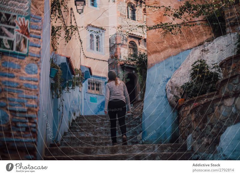 Woman walking upstairs on street Street Morocco Walking Hat Chechaouen Tradition Vacation & Travel Culture City arabic Town Multicoloured Tourism